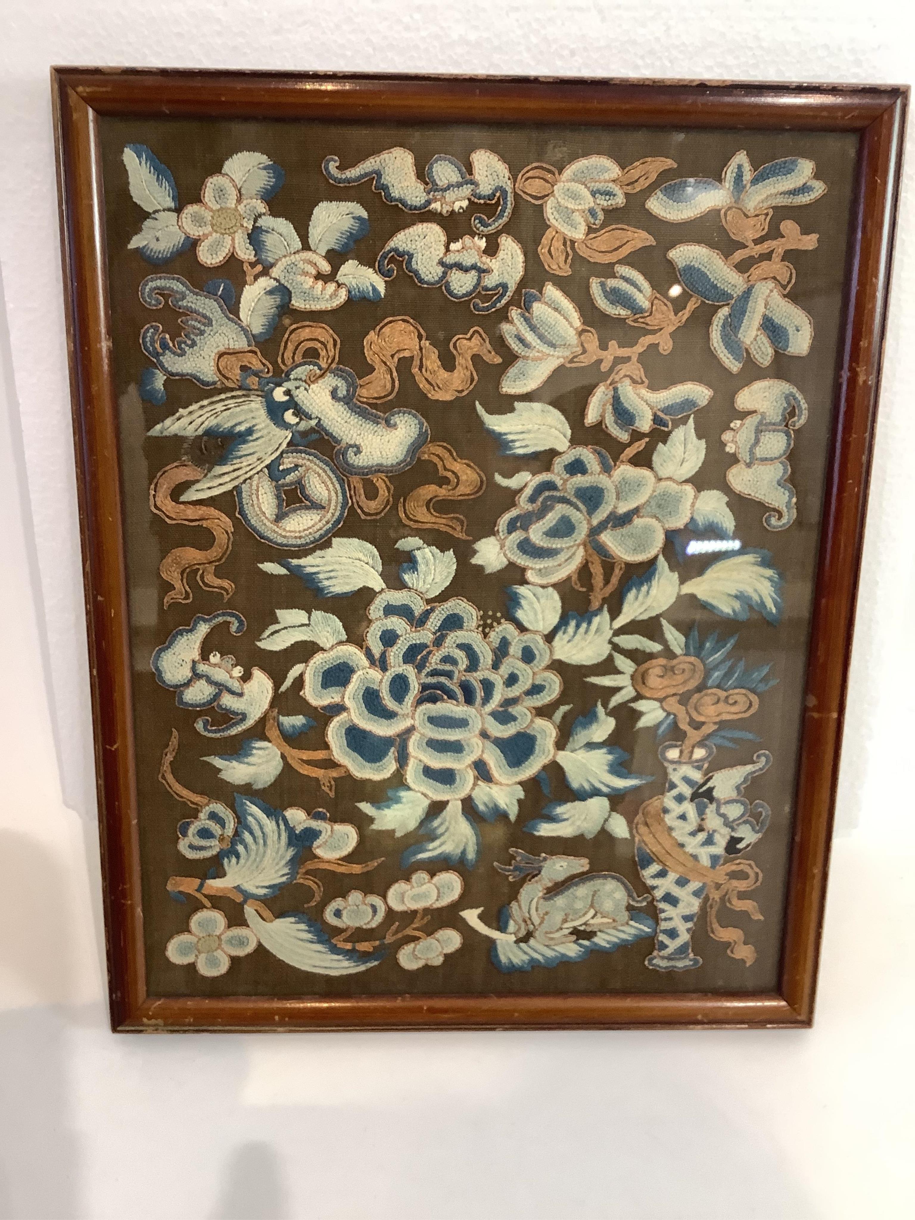 A 19th century framed Chinese Peking knot panel, embroidered on brown silk, in tones of blue, with metallic outlines and high lights on auspicious motifs emblematic of long life and happiness. 28cm x 21.5cm. Condition -